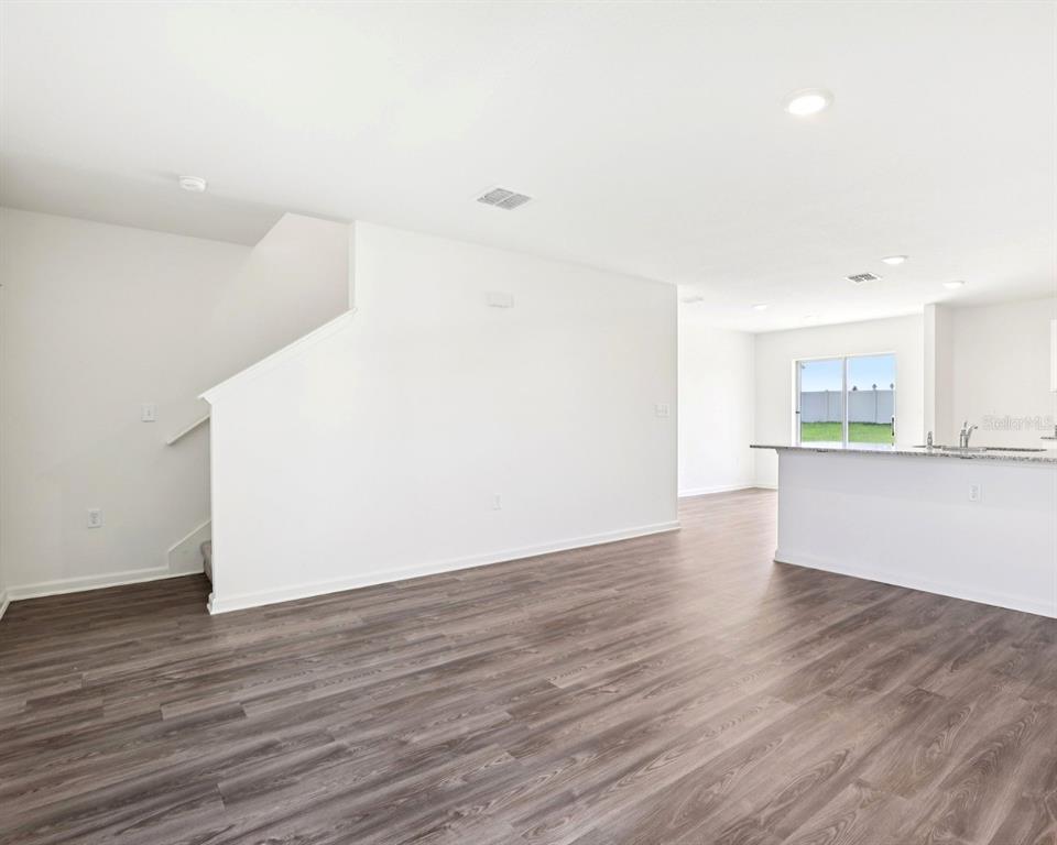 673 Hillview Loop Haines City, FL 33844 - Photo 2 of 14 a view of a kitchen with wooden floor and a sink