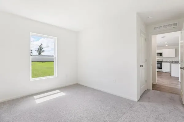 an empty room with windows and closet