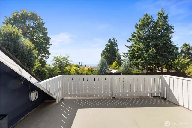 a view of a chairs and table in the roof deck