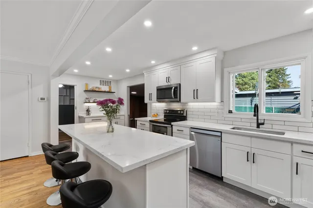 a kitchen with a sink a stove and cabinets