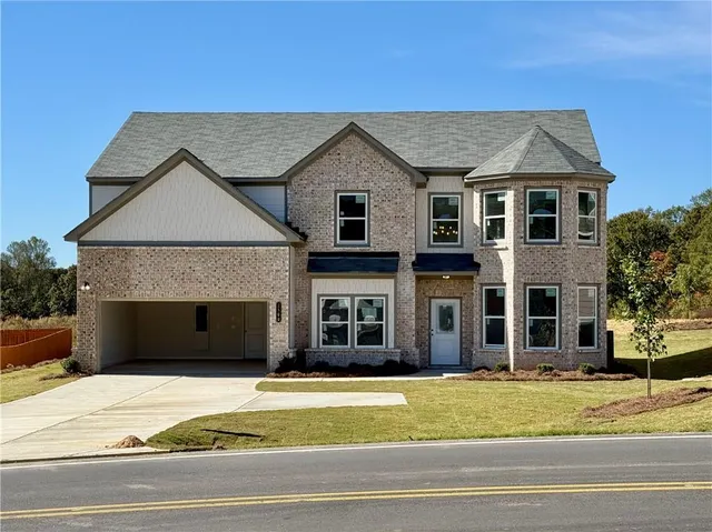 a front view of a house with a yard