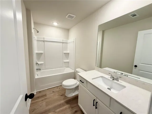 a bathroom with a sink toilet tub and shower