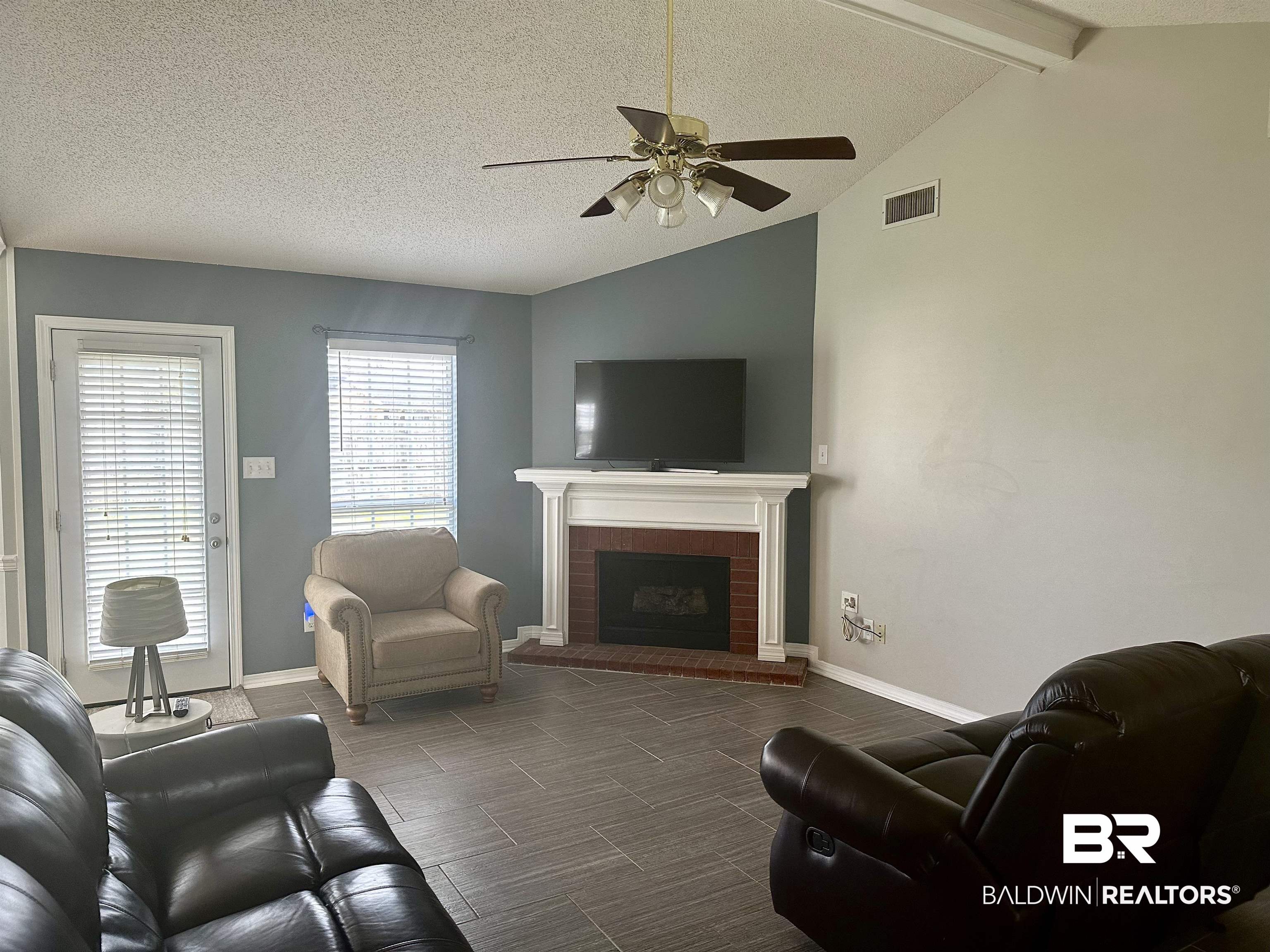 4882 Rebecca Place Mobile, AL 36695 - Photo 23 of 29 Living room with lofted ceiling with beams, visible vents, a textured ceiling, and ceiling fan