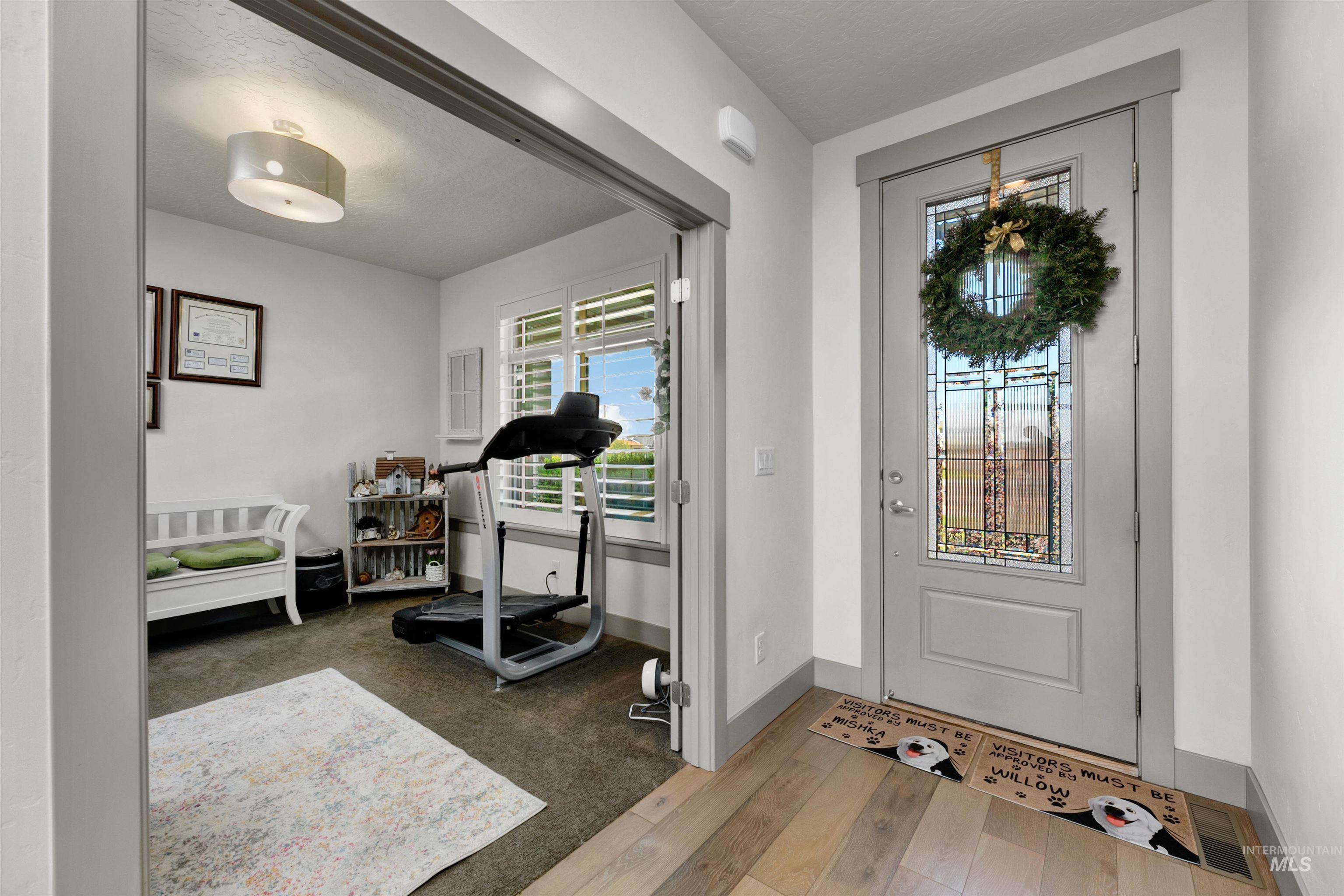24398 Tombstone Ridge Court Middleton, ID 83644 - Photo 6 of 47 Entryway featuring light wood-finish flooring and a door with decorative glass paneling
