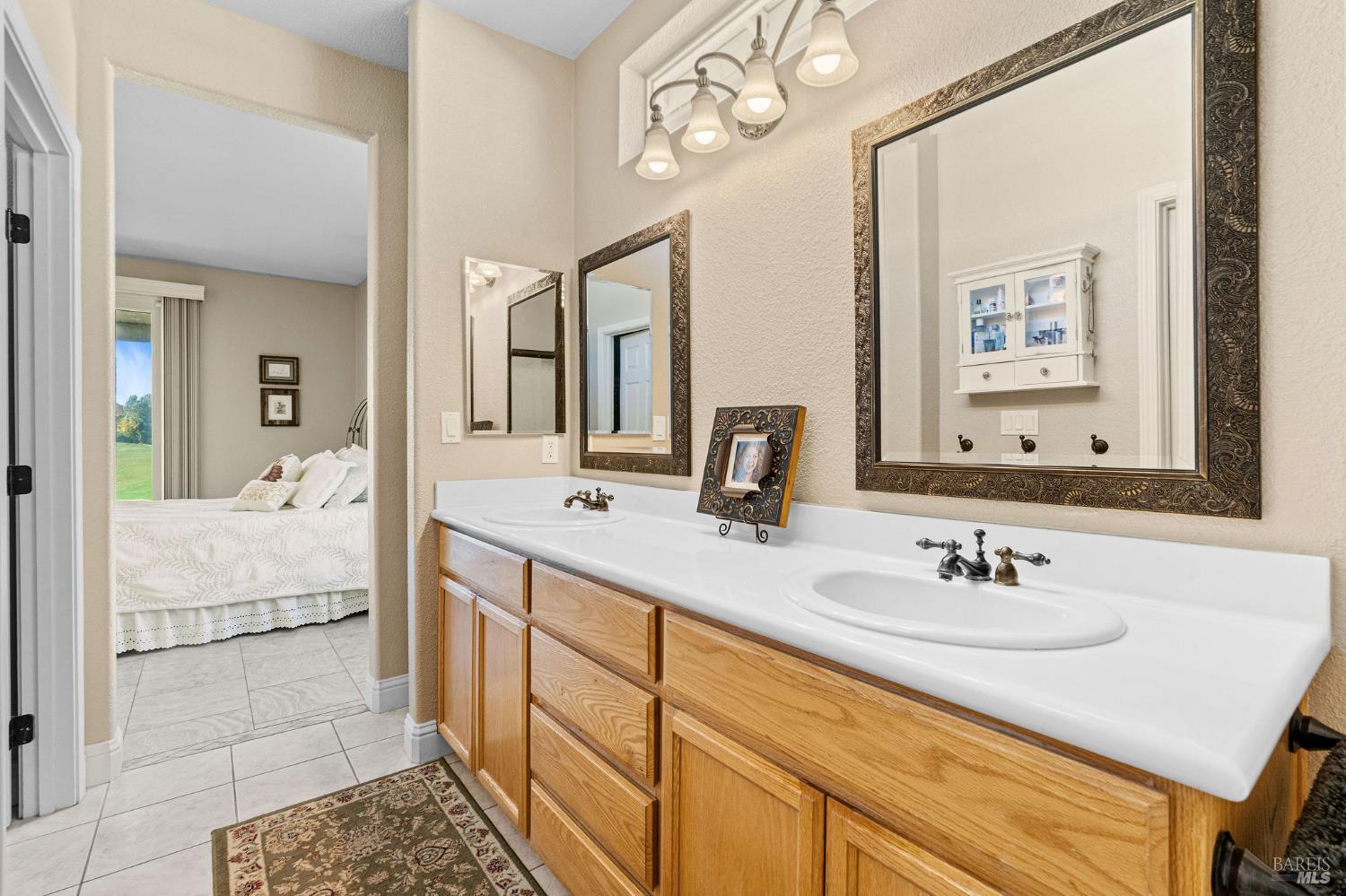 351 Spyglass Drive Rio Vista, CA 94571 - Photo 23 of 63 a en suite bathroom with a double vanity sink and a mirror