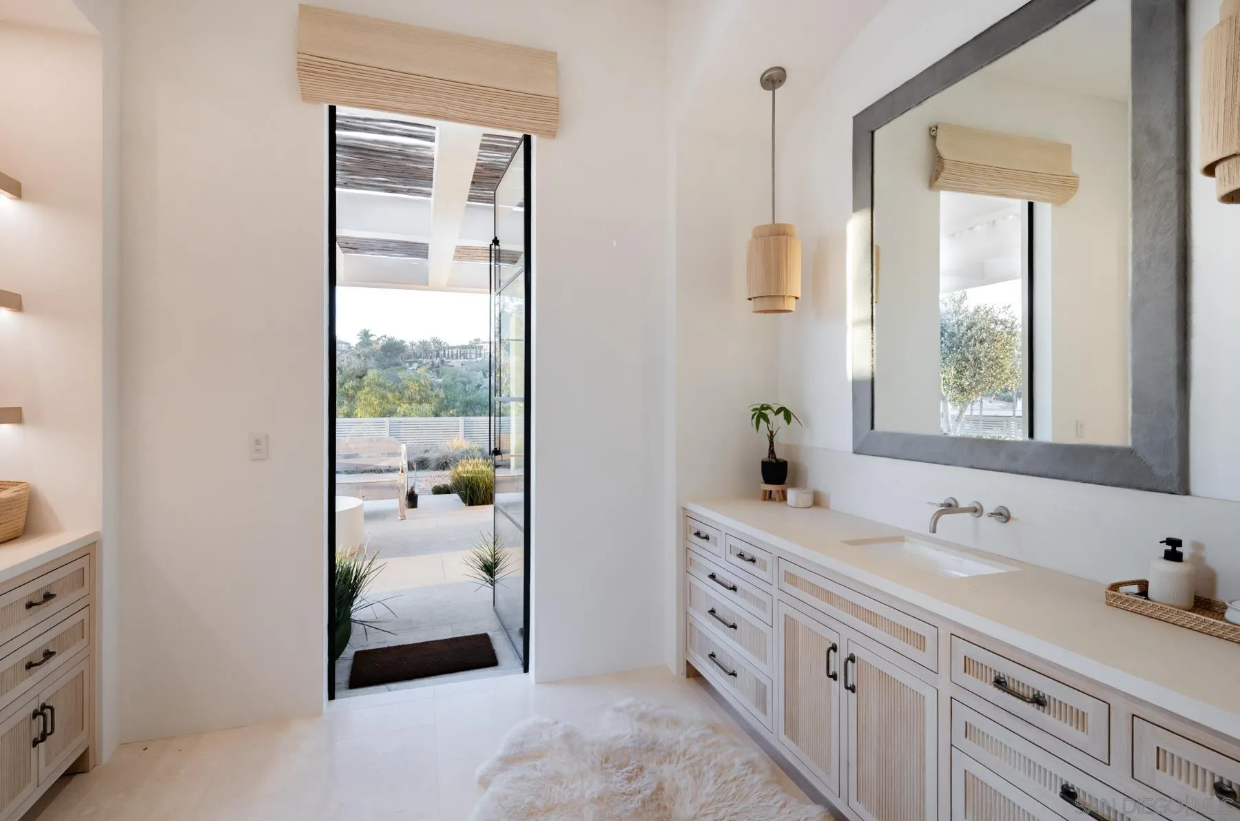 14783 Roxbury Terrace Rancho Santa Fe, CA 92067 - Photo 43 of 64 a bathroom with a double vanity sink a mirror and next to a window