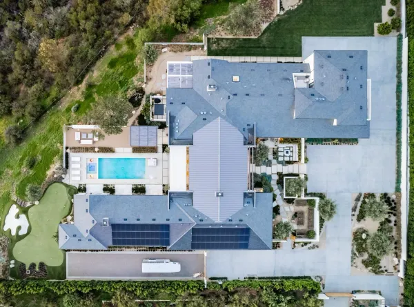 an aerial view of residential houses with outdoor space and street view