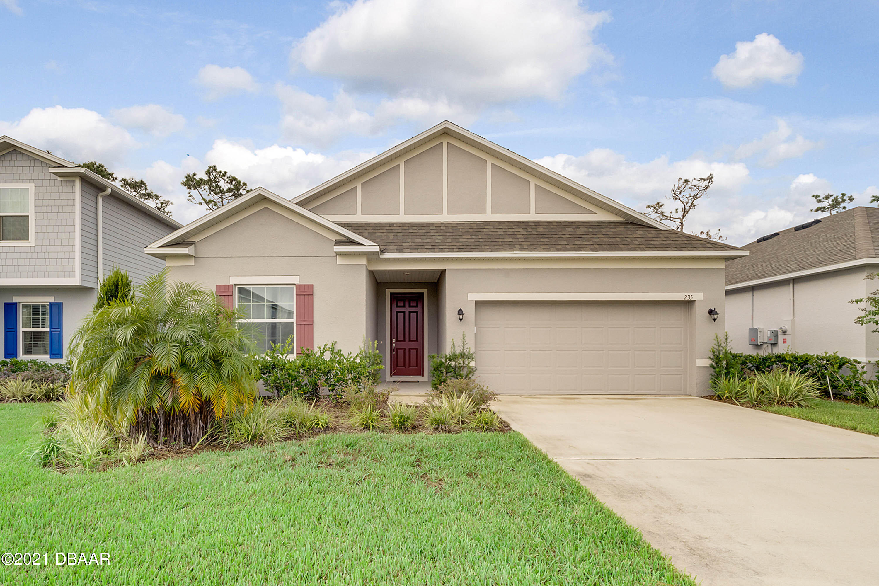 235 Jackson Loop DeLand, FL 32724 - Photo 1 of 27 a front view of a house with a garden and plants