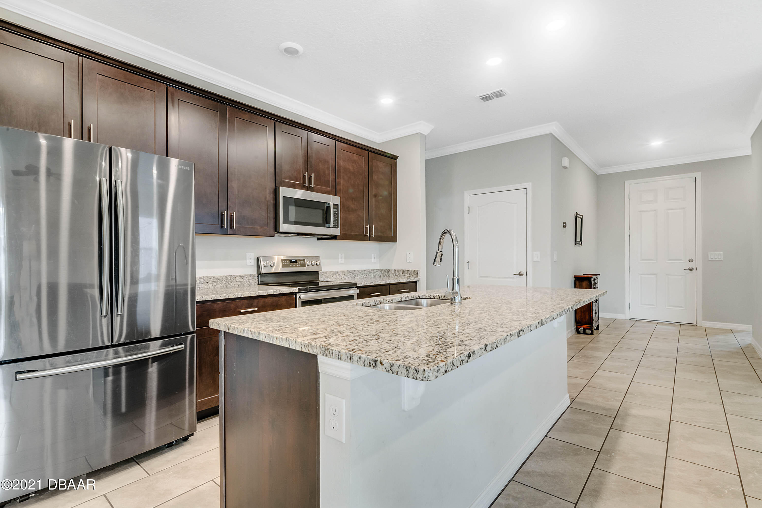235 Jackson Loop DeLand, FL 32724 - Photo 11 of 27 a kitchen with stainless steel appliances granite countertop a refrigerator a stove and a sink