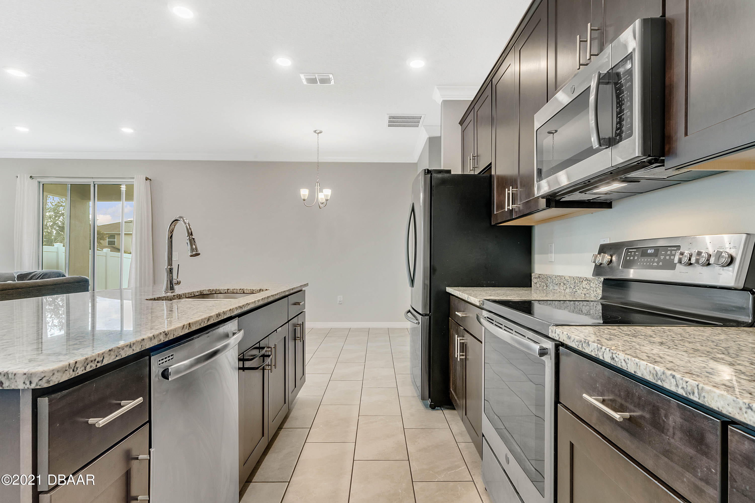 235 Jackson Loop DeLand, FL 32724 - Photo 12 of 27 a kitchen with stainless steel appliances granite countertop a sink a stove and a refrigerator