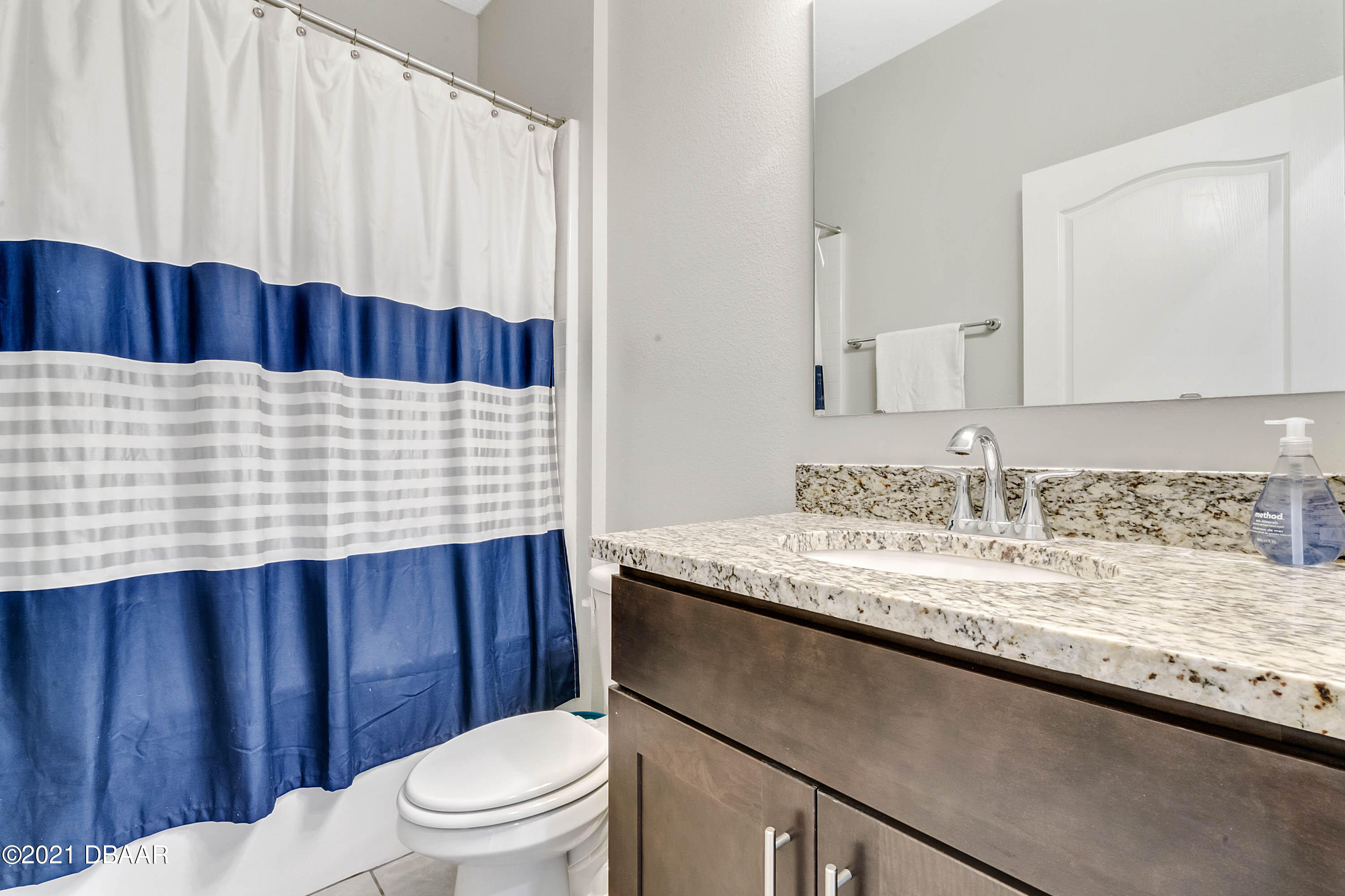 235 Jackson Loop DeLand, FL 32724 - Photo 20 of 27 a bathroom with a granite countertop sink and a mirror