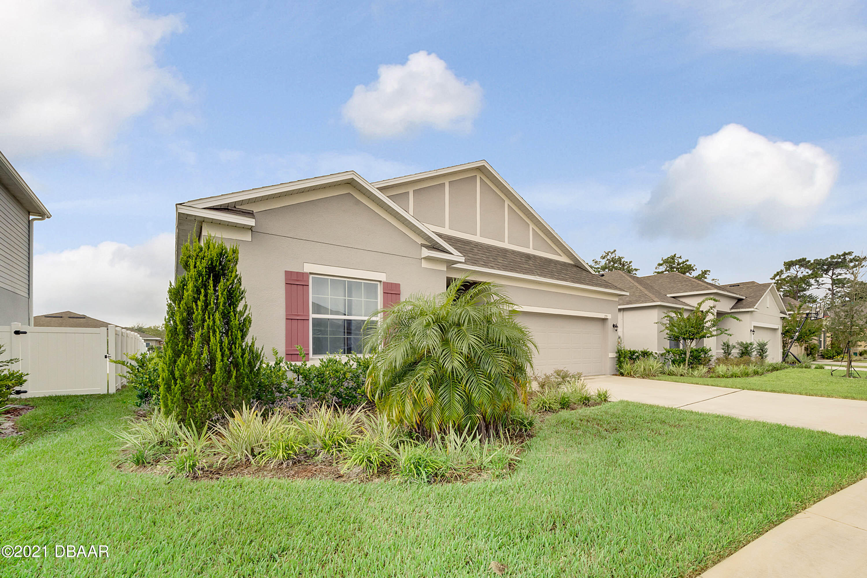 235 Jackson Loop DeLand, FL 32724 - Photo 2 of 27 a front view of a house with a garden