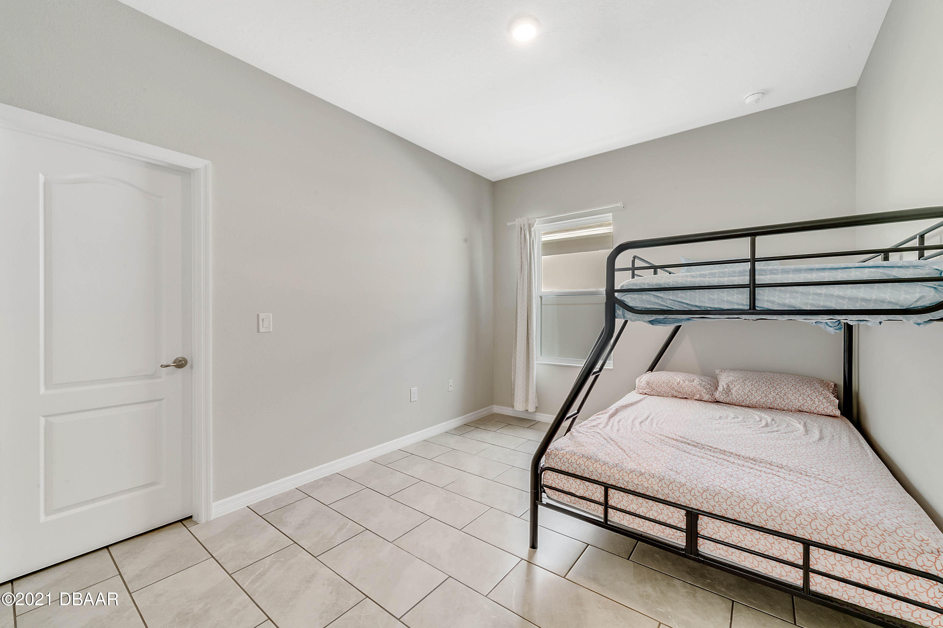 235 Jackson Loop DeLand, FL 32724 - Photo 21 of 27 a bedroom with a bed and lamp