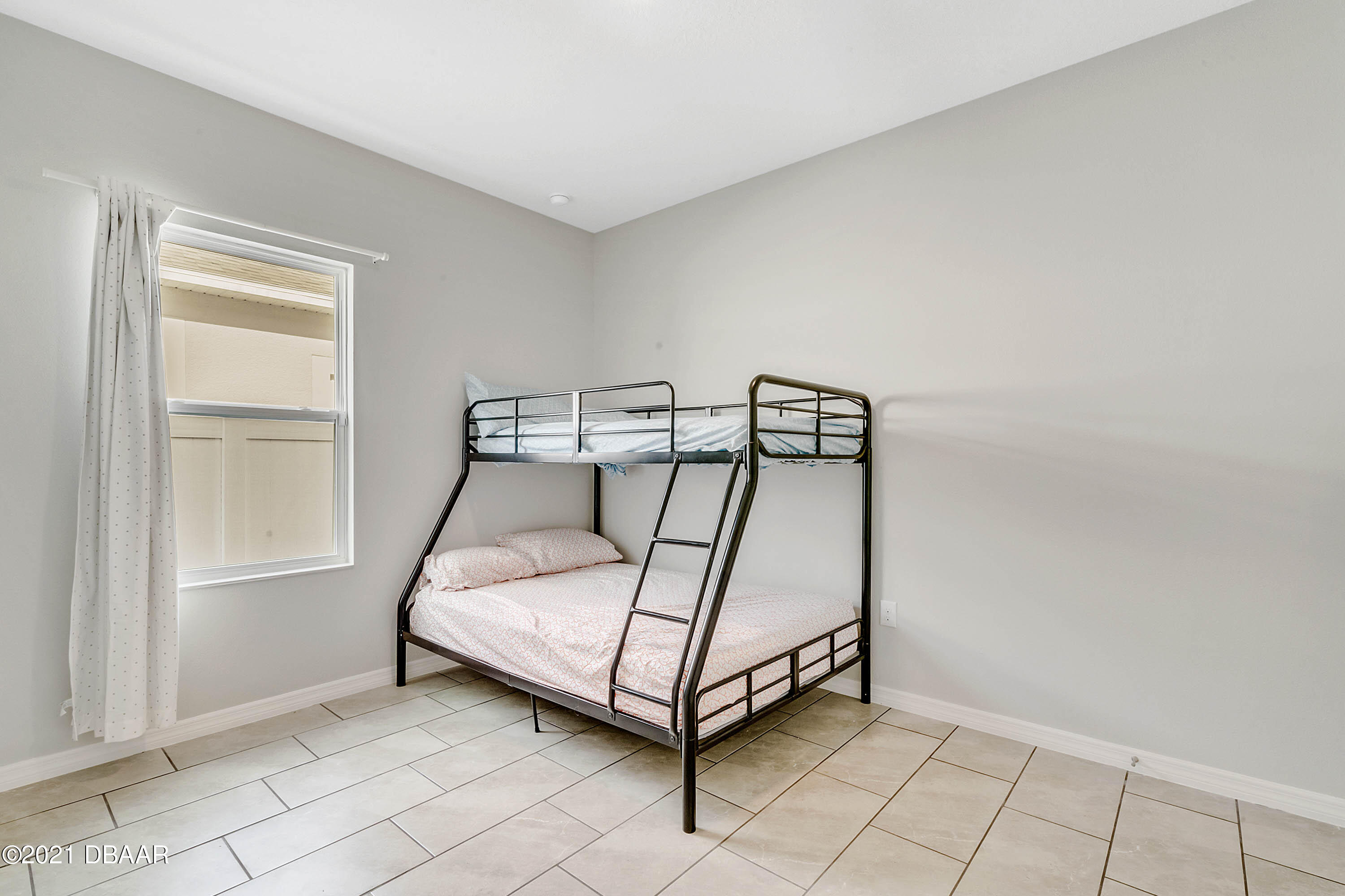 235 Jackson Loop DeLand, FL 32724 - Photo 22 of 27 a white bed sitting in a room next to a window