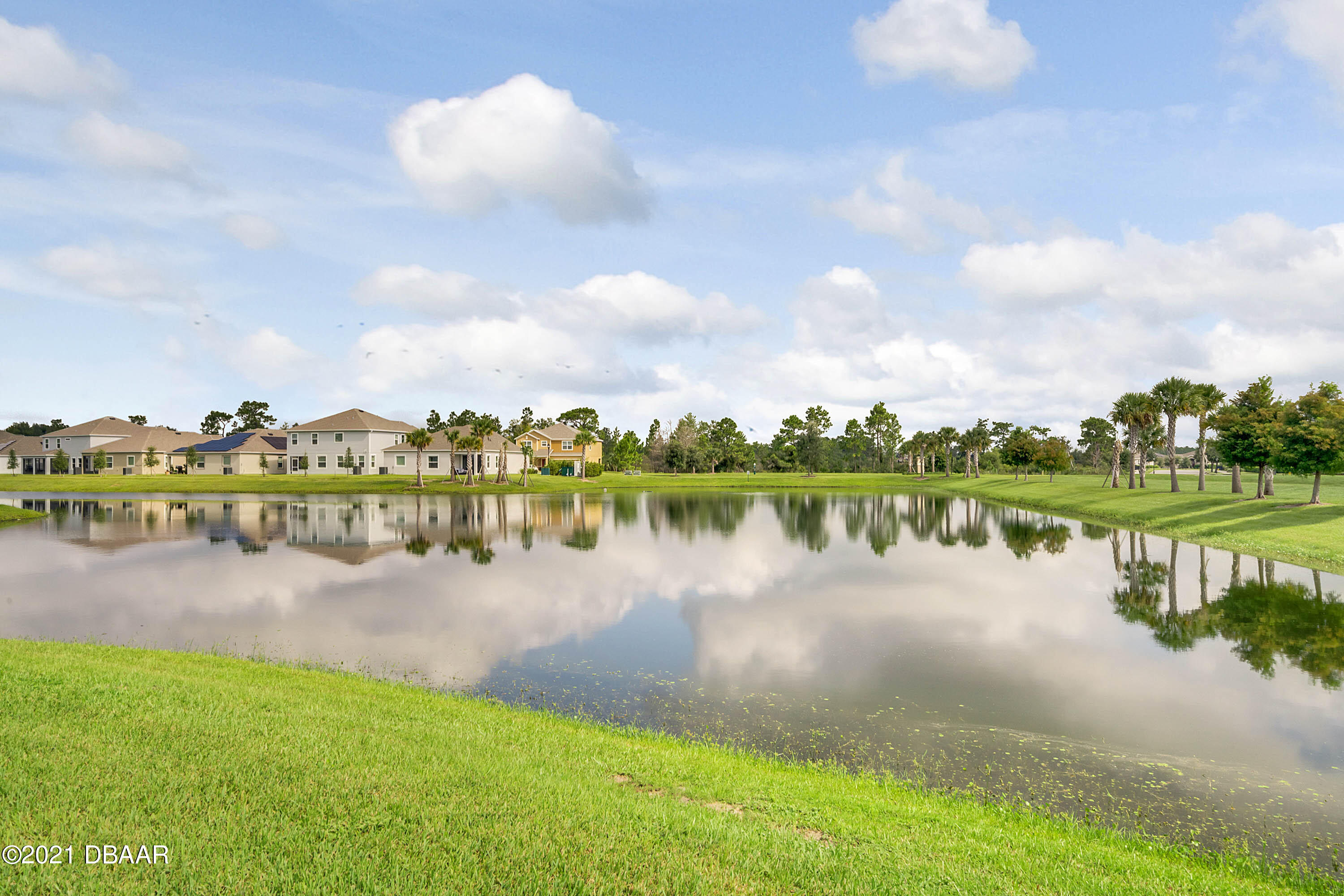 235 Jackson Loop DeLand, FL 32724 - Photo 26 of 27 a view of a lake with houses in the back