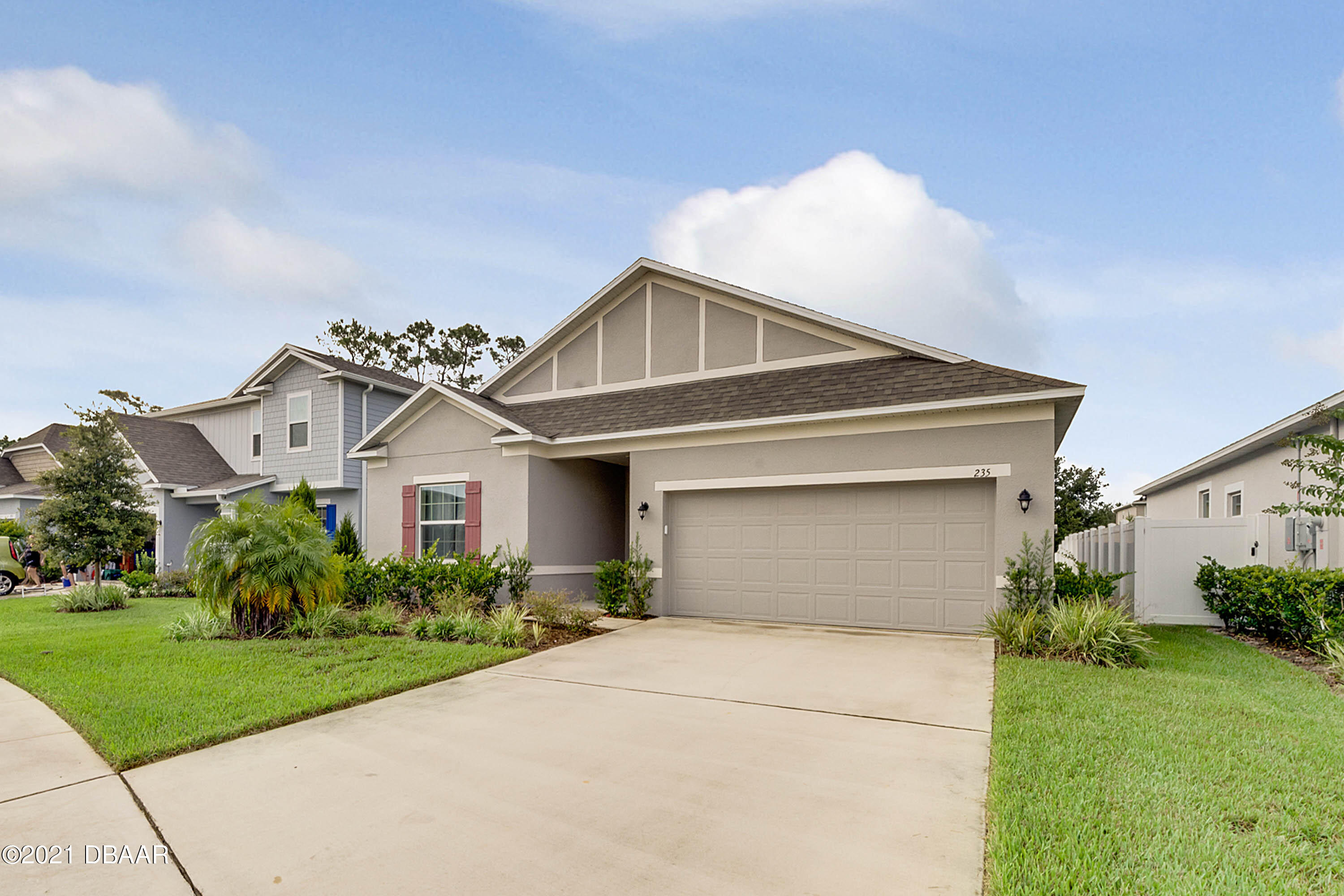 235 Jackson Loop DeLand, FL 32724 - Photo 3 of 27 a front view of a house with a yard and garage