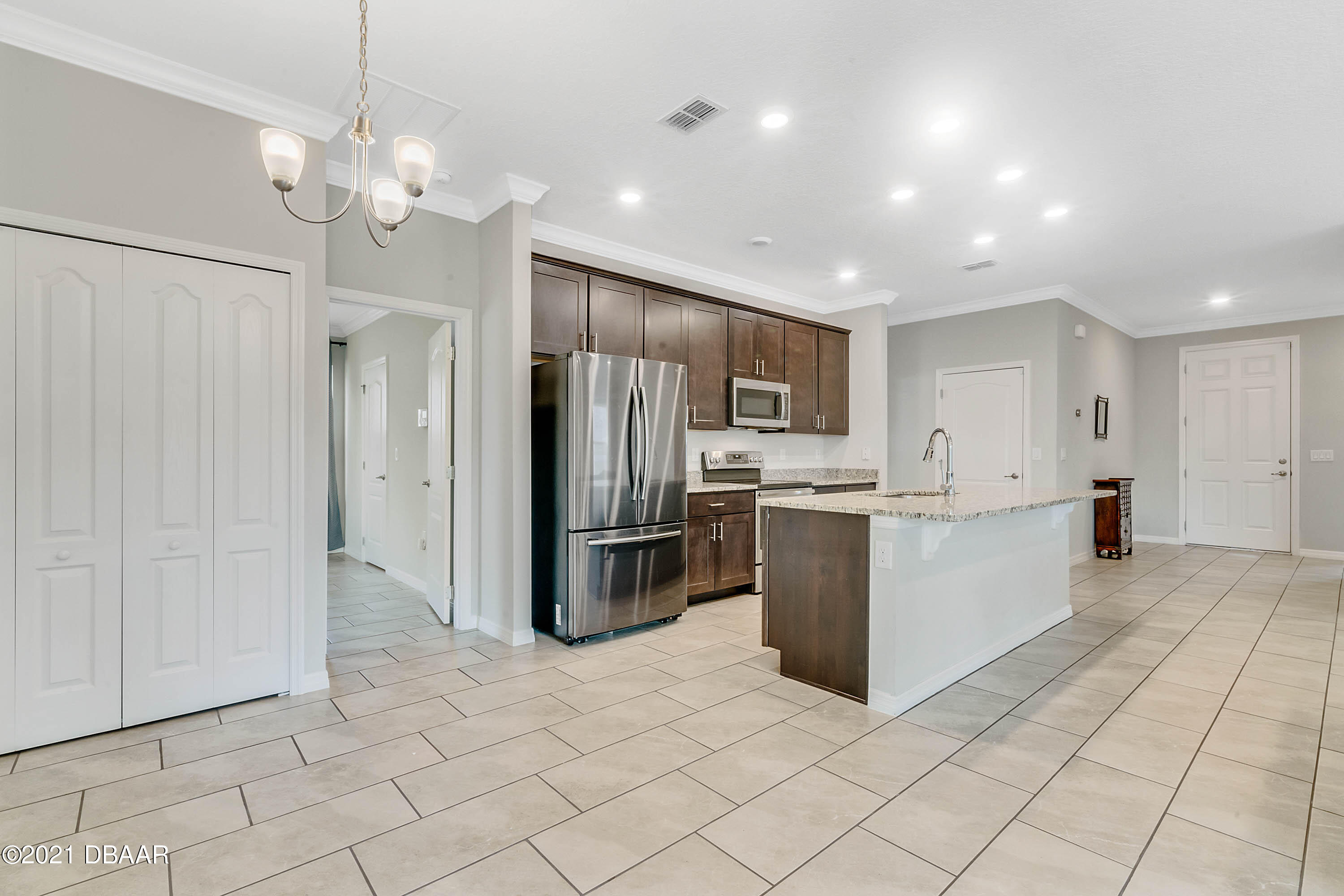235 Jackson Loop DeLand, FL 32724 - Photo 9 of 27 a kitchen with a refrigerator and a sink