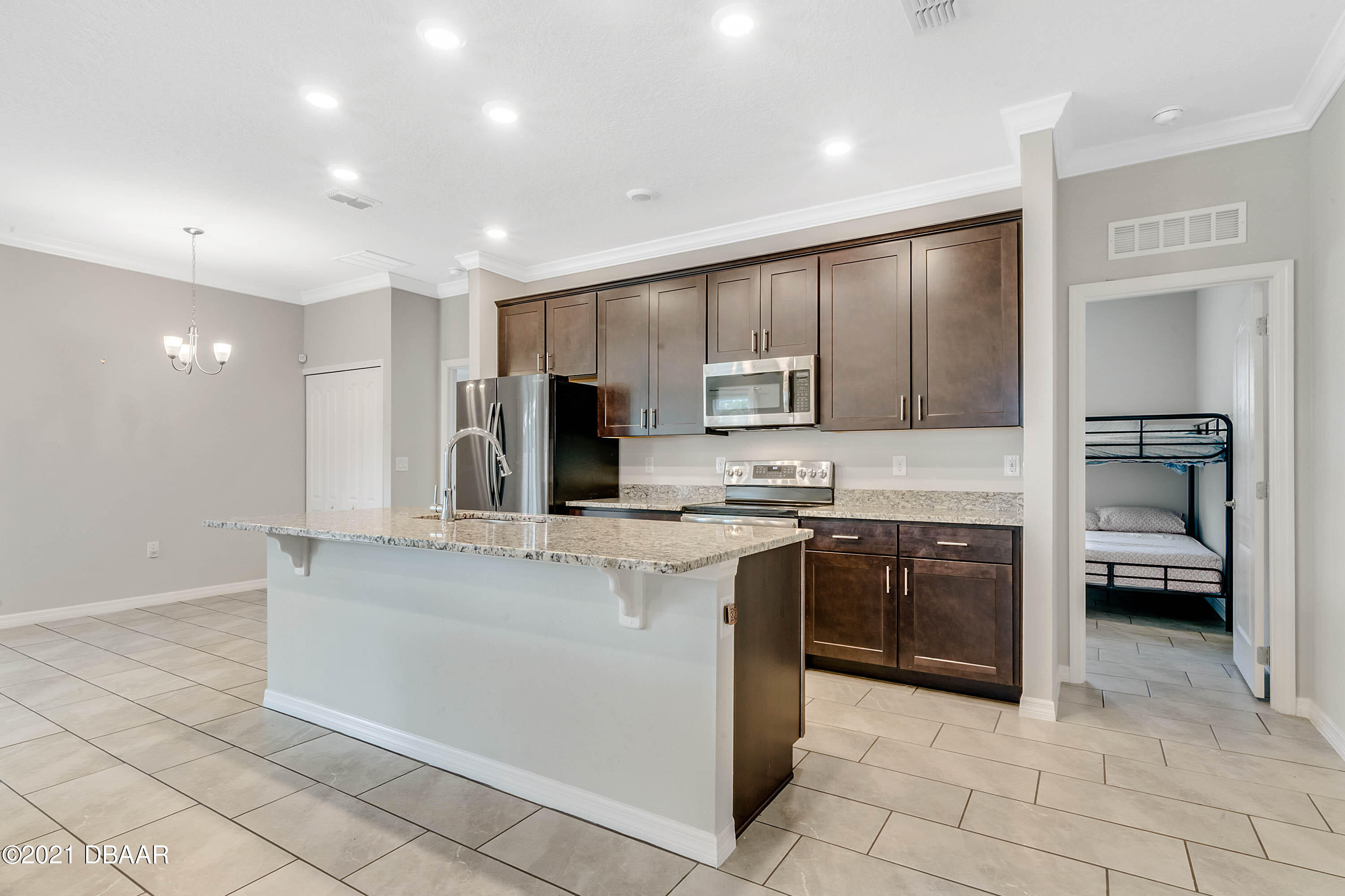 235 Jackson Loop DeLand, FL 32724 - Photo 10 of 27 a kitchen with stainless steel appliances granite countertop a stove a sink and a refrigerator