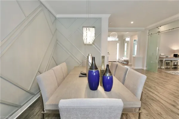 a dining room with furniture and a chandelier