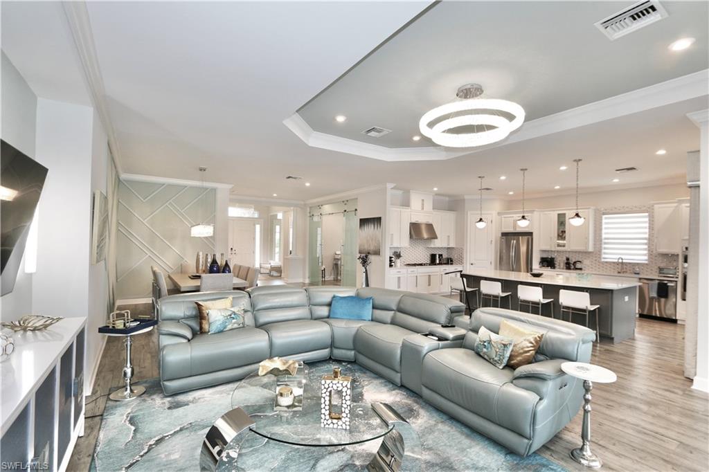 8337 Promoso Court Naples, FL 34114 - Photo 20 of 48 Living area with crown molding, light wood-style floors, and recessed lighting