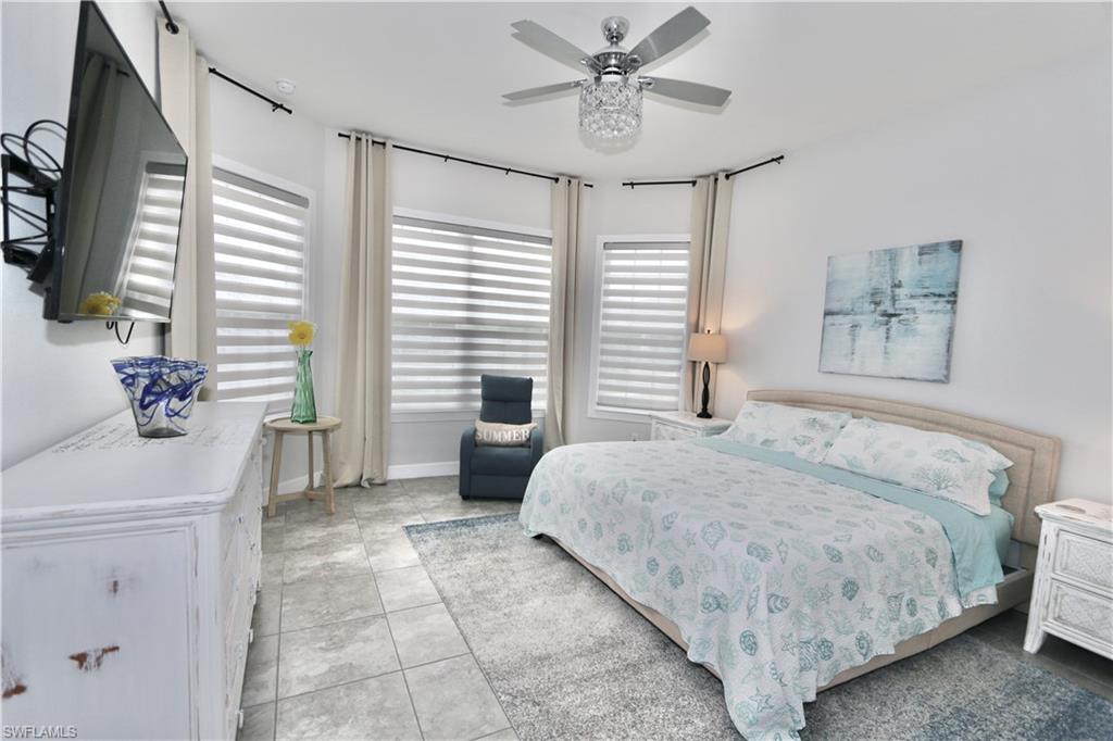 8337 Promoso Court Naples, FL 34114 - Photo 21 of 48 Bedroom with a ceiling fan and light tile patterned flooring