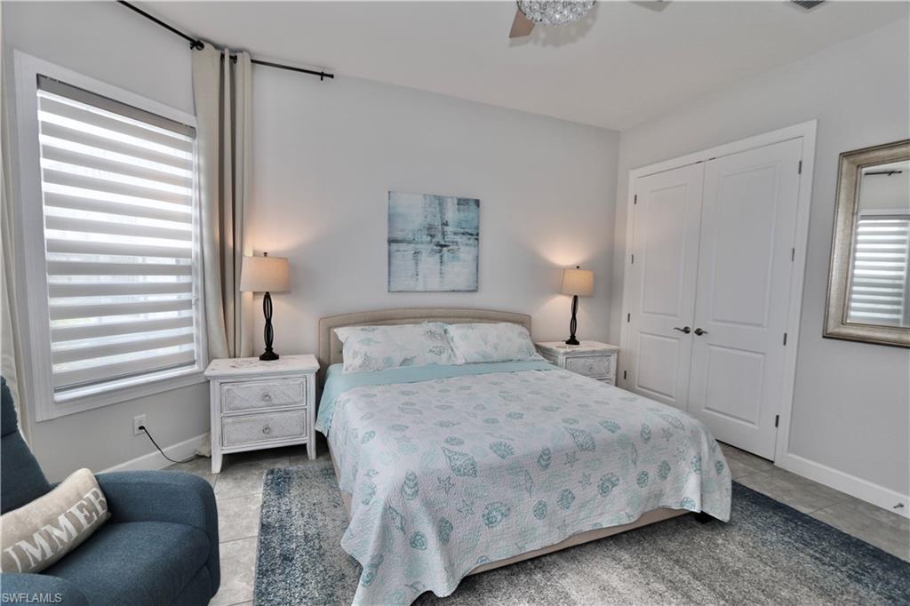 8337 Promoso Court Naples, FL 34114 - Photo 22 of 48 Bedroom with a closet, light tile patterned flooring, and a ceiling fan