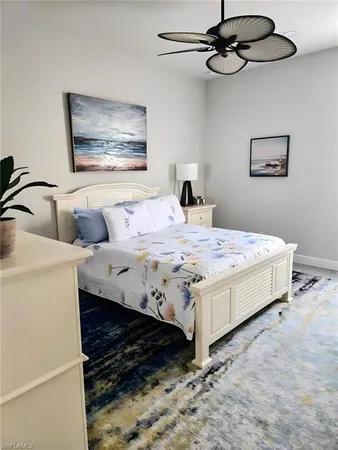 a bed room with a bed and a chandelier