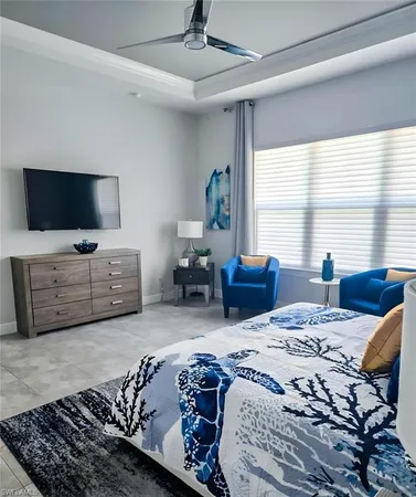 a bedroom with a bed window and a flat screen television