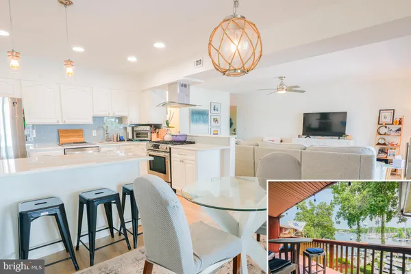 a kitchen with stainless steel appliances granite countertop a stove a refrigerator a microwave oven a dining table and chairs with wooden floor