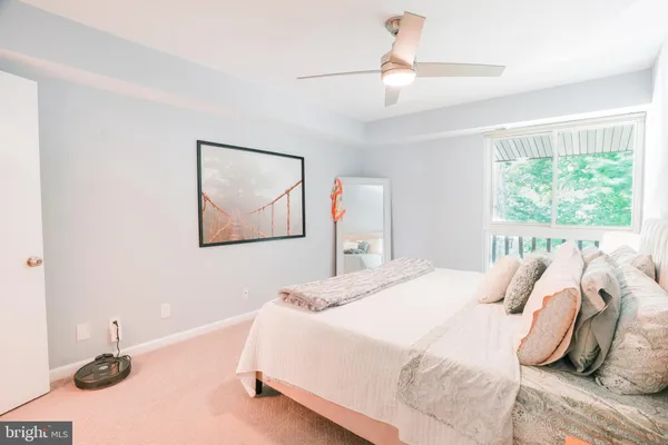 a bedroom with a bed and a painting on the wall