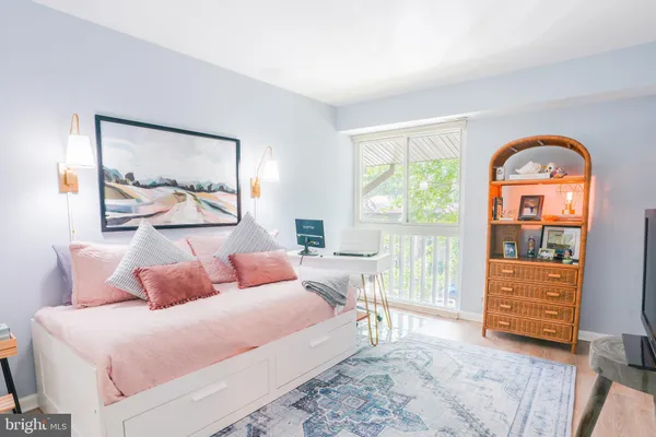 a bedroom with a bed and a painting on the wall