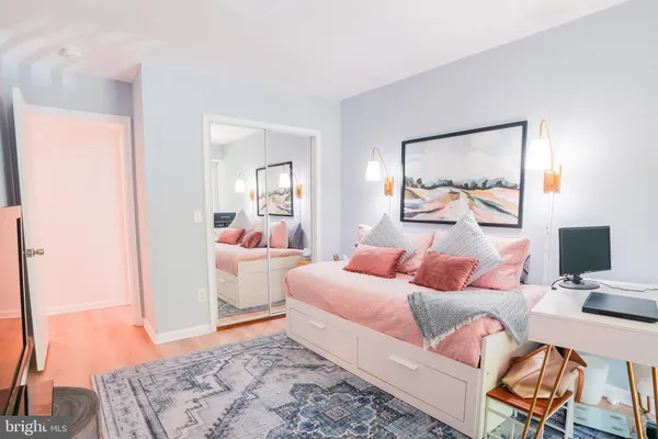 a bedroom with a bed and wooden floor