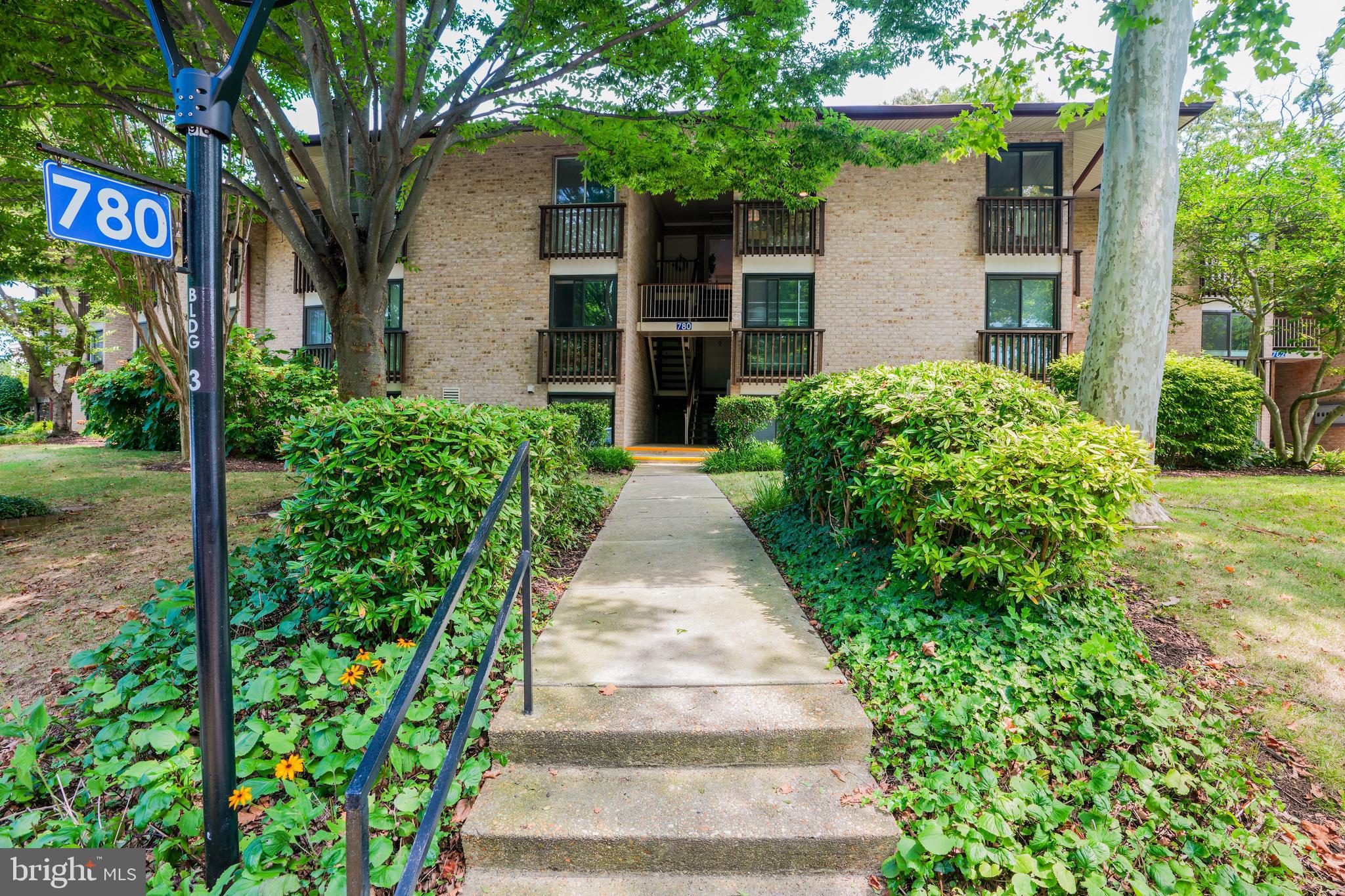 780 F Fairview Avenue, Unit F Annapolis, MD 21403 - Photo 27 of 28 a front view of a house with a yard and potted plants