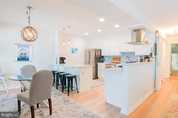 a view of kitchen with stainless steel appliances granite countertop living room and microwave