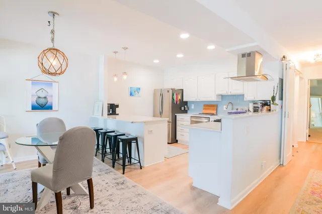 a view of kitchen with stainless steel appliances granite countertop living room and microwave
