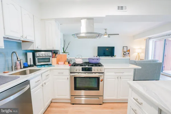 a kitchen with cabinets and stainless steel appliances
