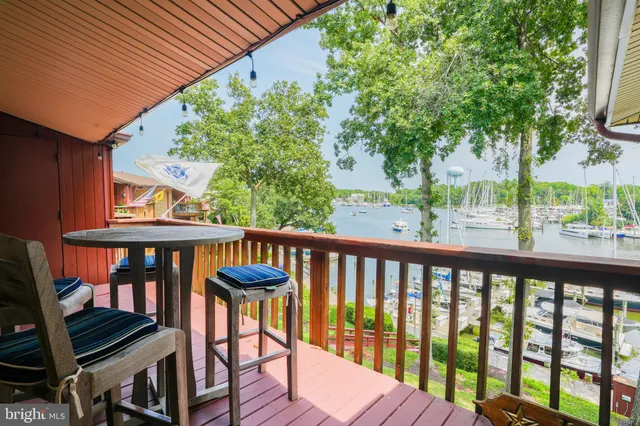 a view of a balcony with wooden floor and outdoor seating
