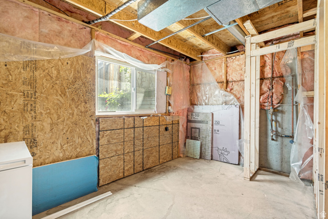843 Deer Flat Road Tooele, UT 84074 - Photo 23 of 27 Unfinished basement space featuring a window, exposed wood framing, concrete flooring, and visible insulation