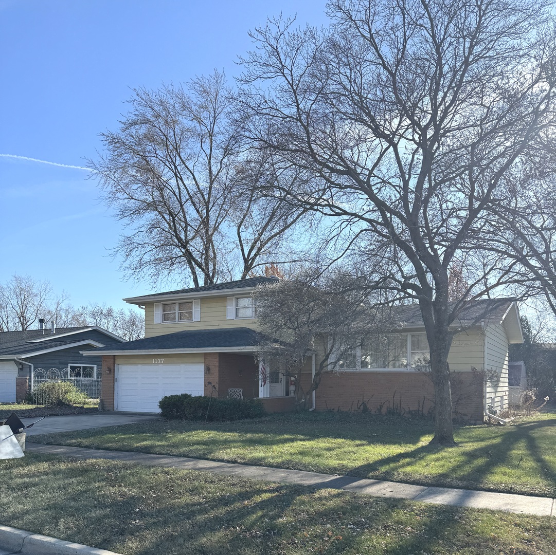 1177 Meadow Lane Elgin, IL 60123 - Photo 1 of 1 a view of a house with a big yard and large trees