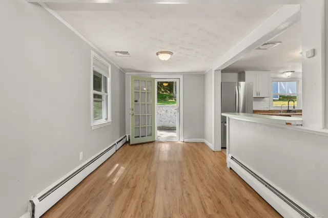 wooden floor in an empty room with a window
