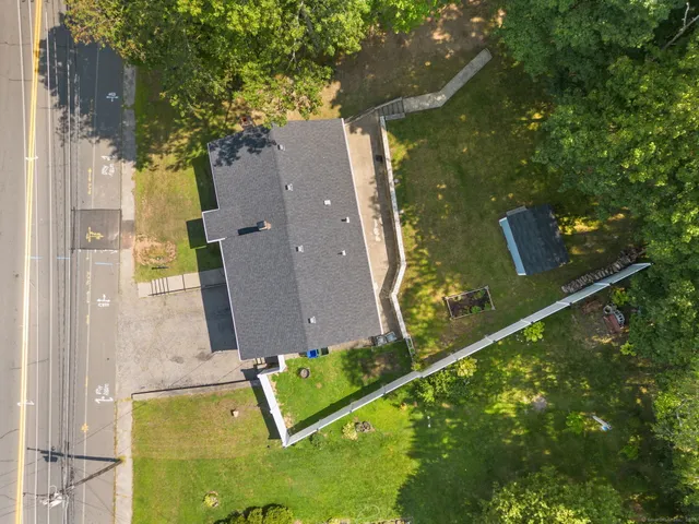 an aerial view of a house with a yard