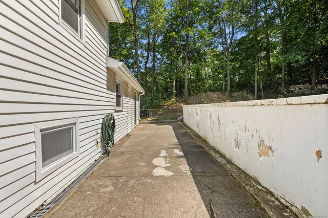 a view of a white house with a yard and pathway