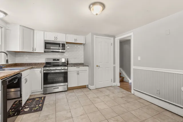 a kitchen with stainless steel appliances a stove sink and cabinets