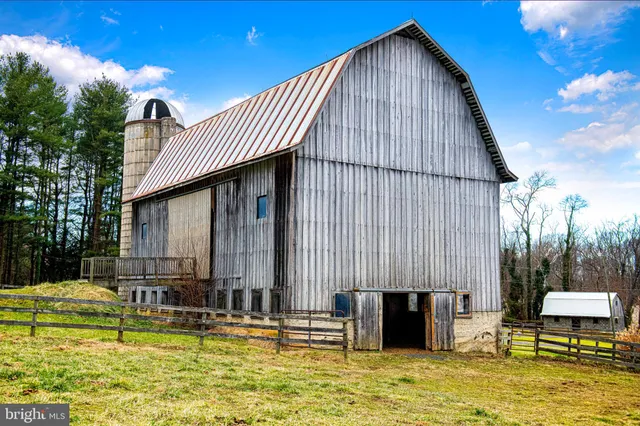 an aerial view of a swimming pool with seating area