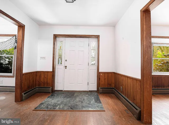a view of front door with furniture and a fireplace