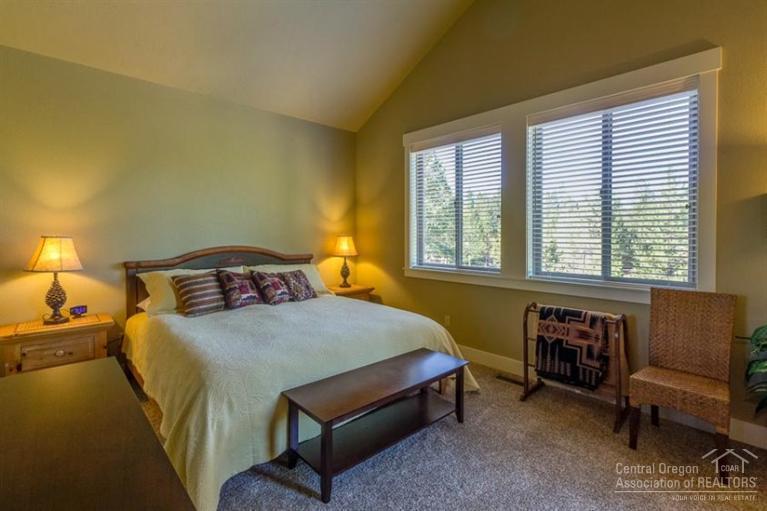 22 Oregon Loop Sunriver, OR 97707 - Photo 15 of 25 a bedroom with a bed and a couch next to a window