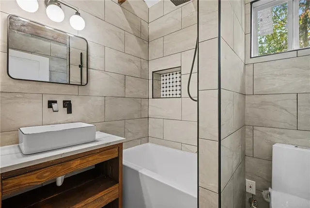 a view of a small space with wooden floor and a window