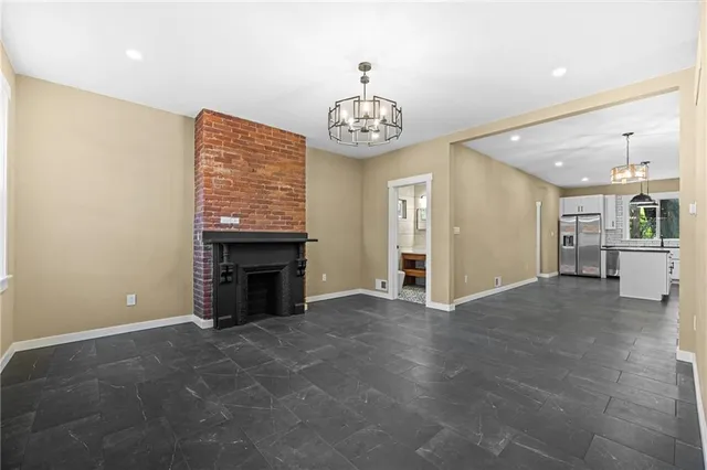 a view of an empty room with a fireplace