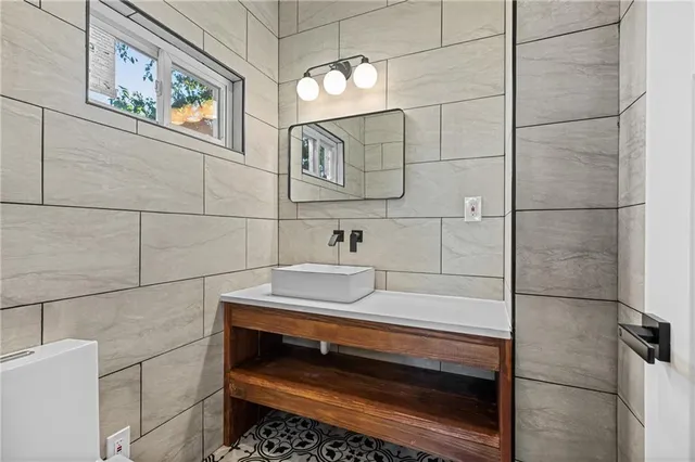 a kitchen with a refrigerator a stove and white cabinets