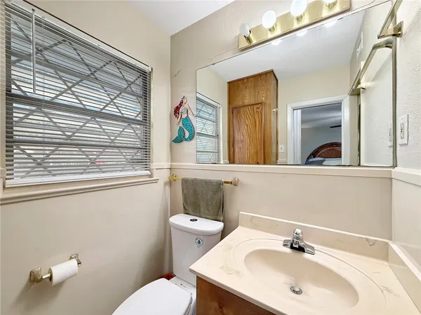 a bathroom with a sink a mirror and a toilet